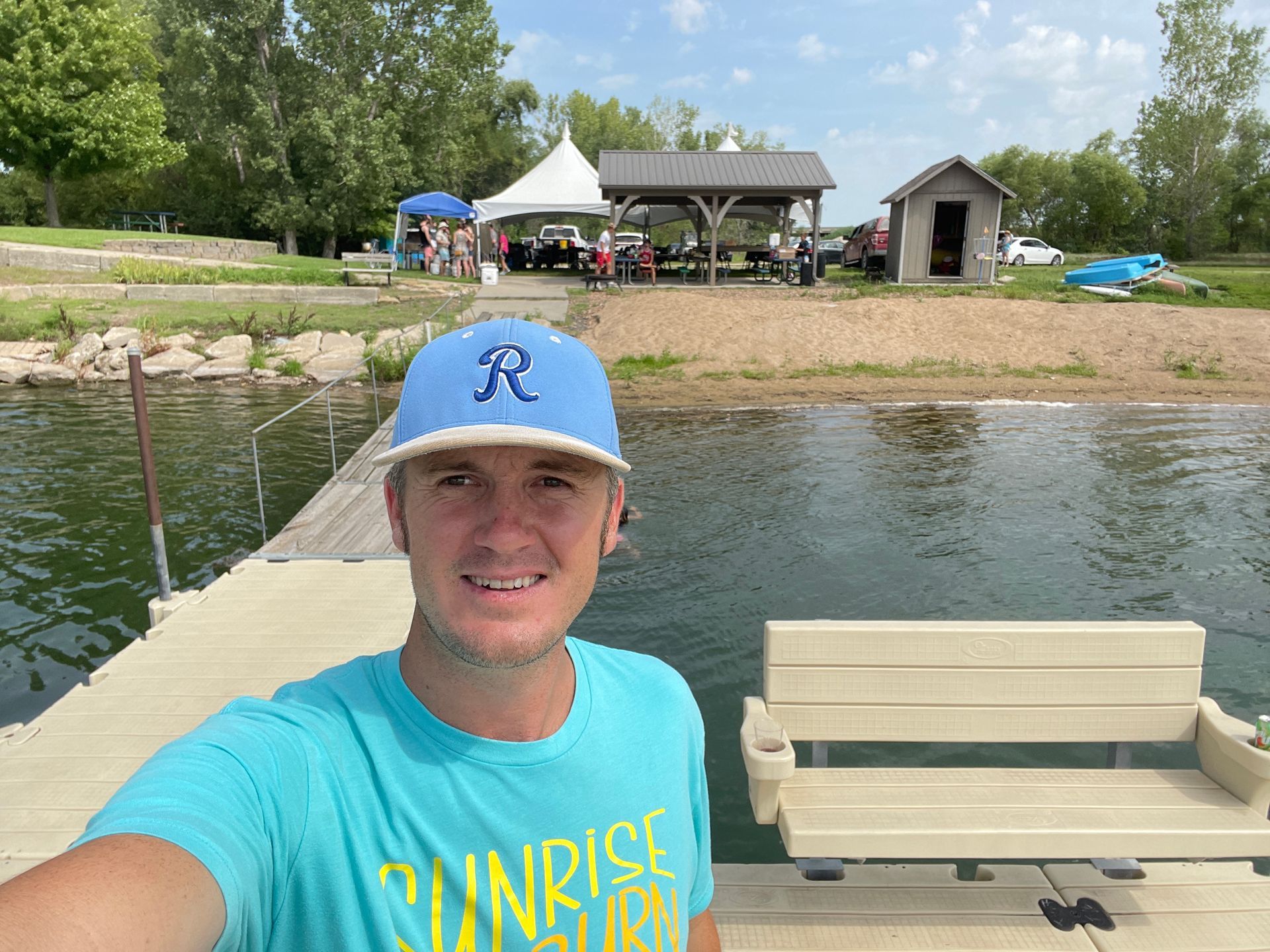 A man takes a selfie while standing by the beach at the ICL Family Picnic.