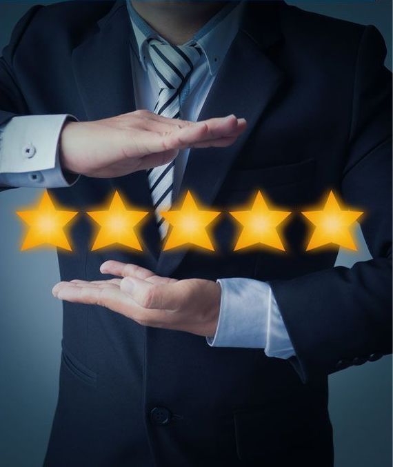 Man in suit holding five glowing golden stars between his hands, symbolizing excellent service.