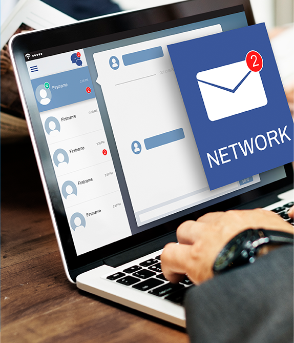 Person using a laptop, a social media message icon with two notifications is in the corner.