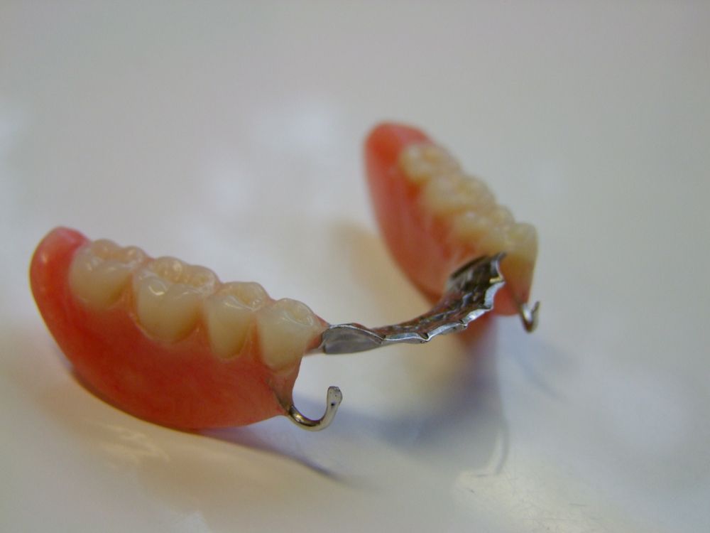 A Close Up Of A Pair Of Dentures On A White Surface — Dentures Direct Taree-Rod Hinton In Laurieton, NSW