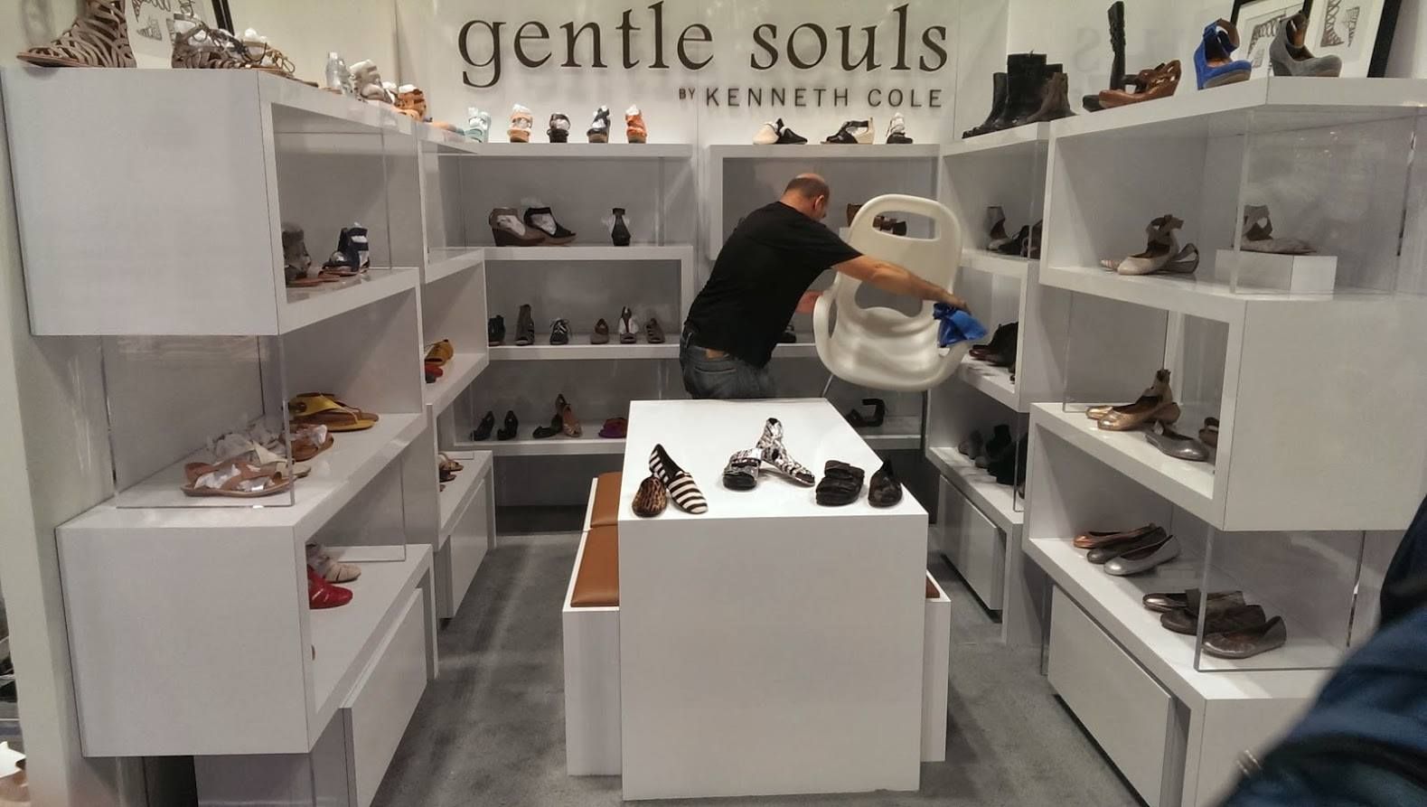 Man organizing shoes in a white 