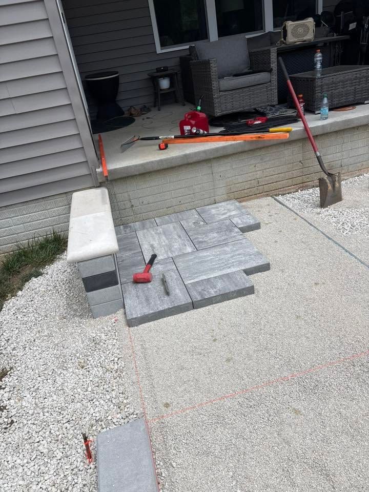 Partially built concrete steps with cinder blocks and tools beside a house porch