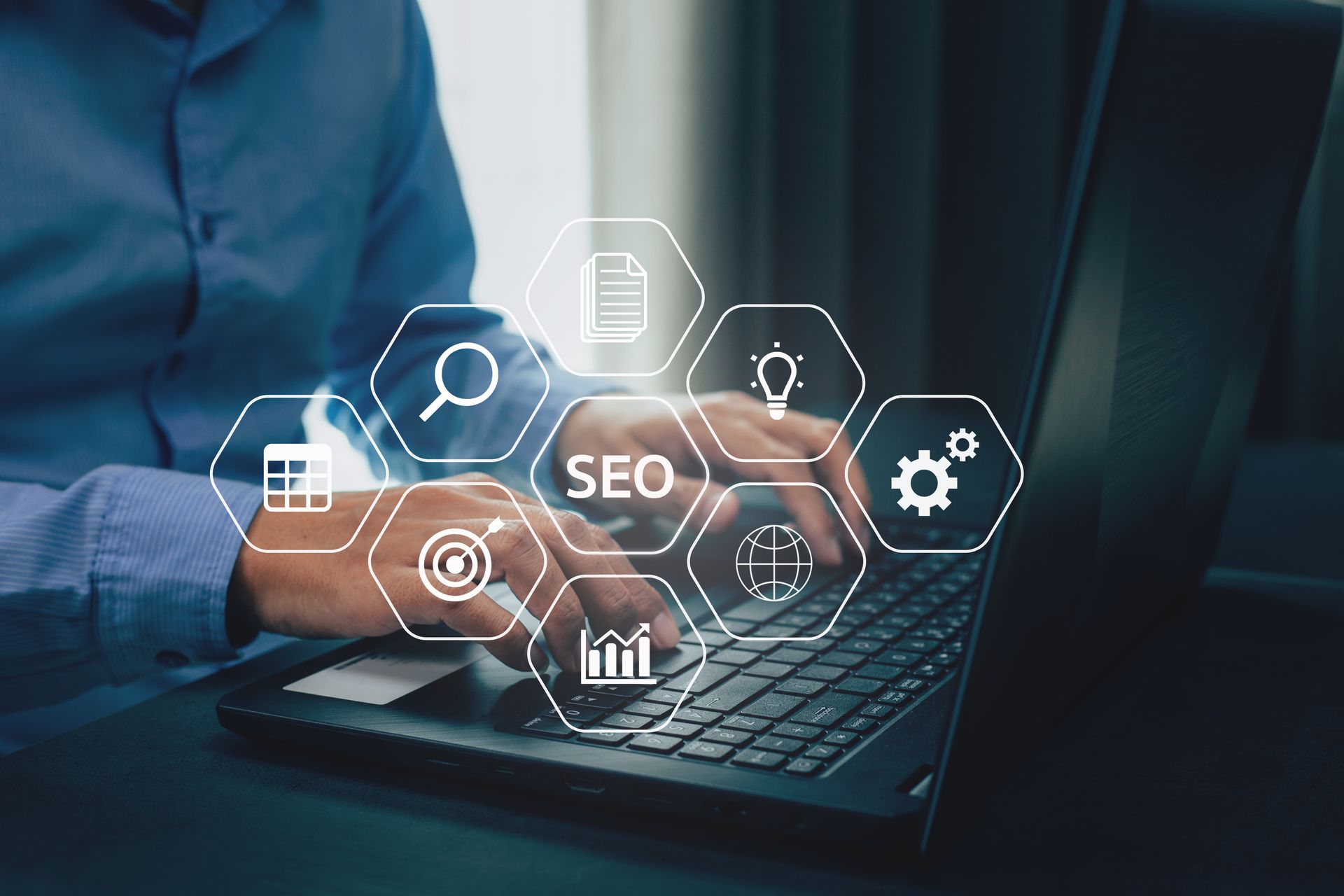 Person tippt auf einem Laptop, darüber liegen SEO-Symbole: Lupe, Dokument, Ziel, Diagramm.