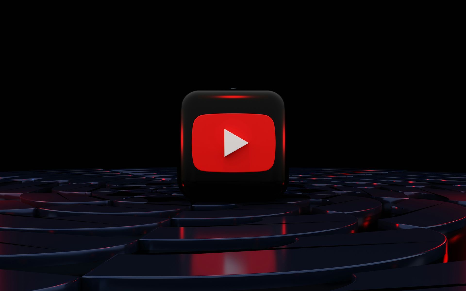 Ein rotes youtube-Symbol befindet sich auf einem schwarzen Würfel.