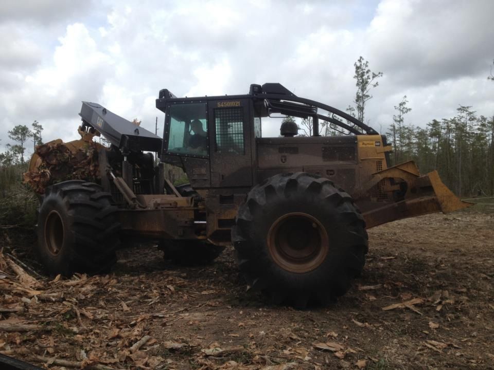 A large tractor is sitting in the middle of a forest