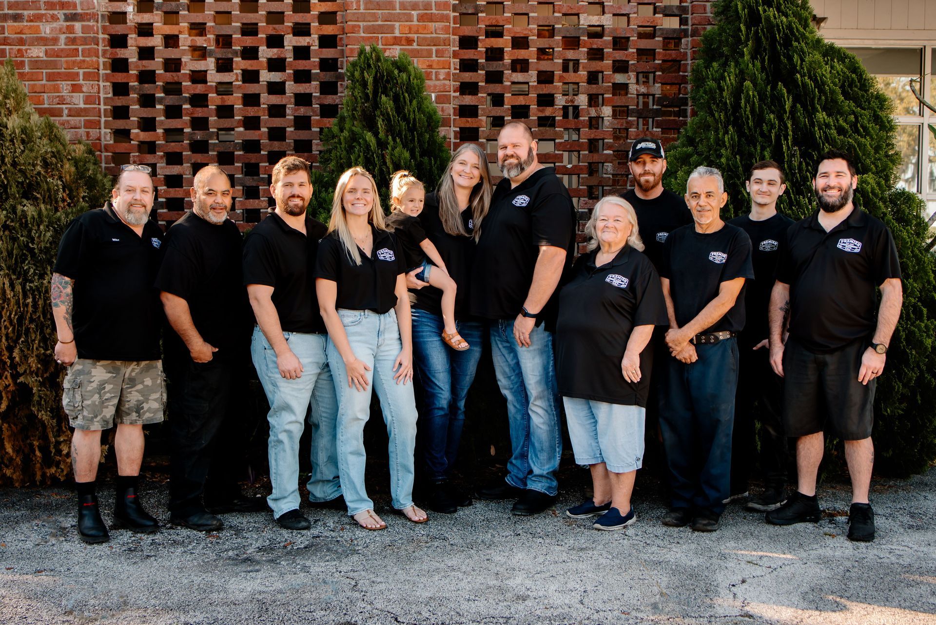 A group of people are posing for a picture in front of a building.