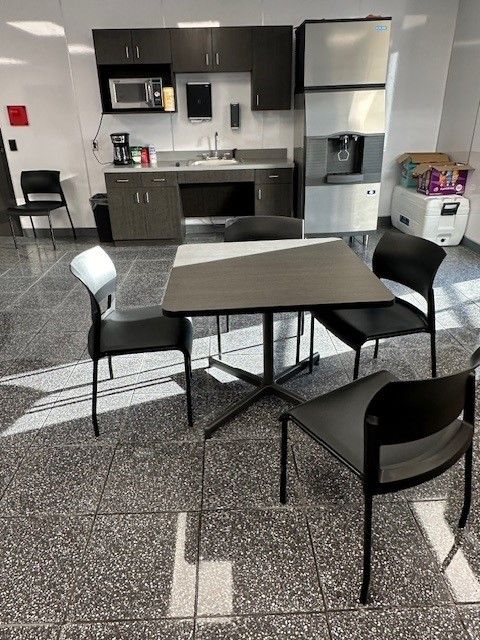 Break room with a table, chairs, sink, cabinets, microwave, coffee maker, and ice machine.