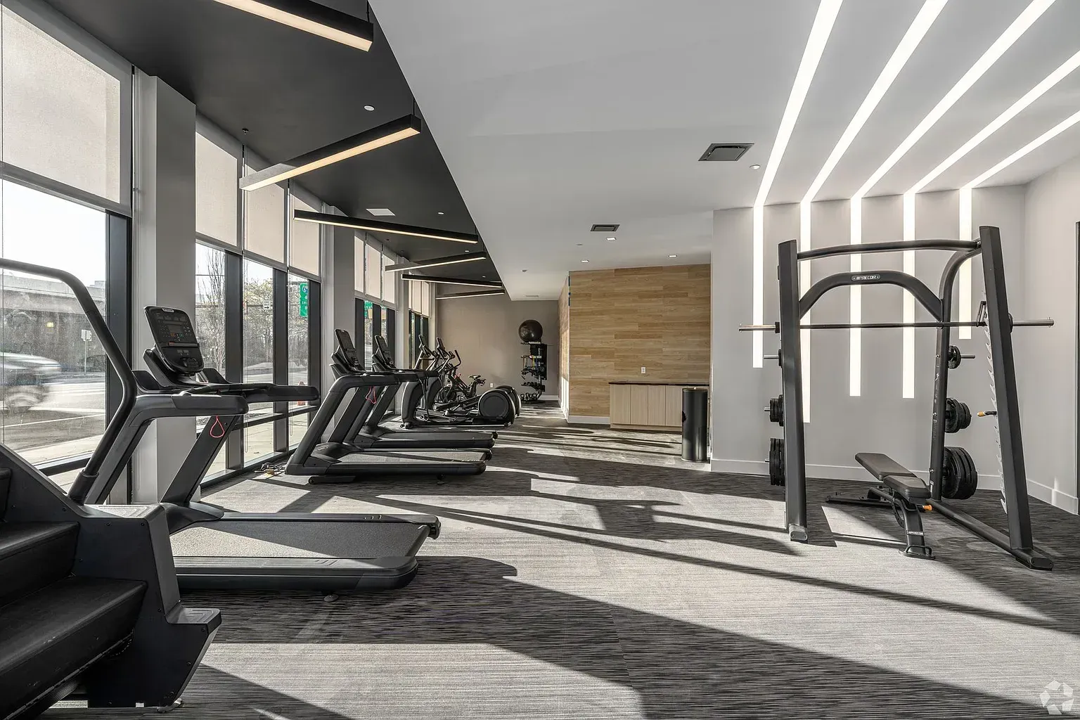 Photo of a gym with plenty of natural lighting and a variety of equipment