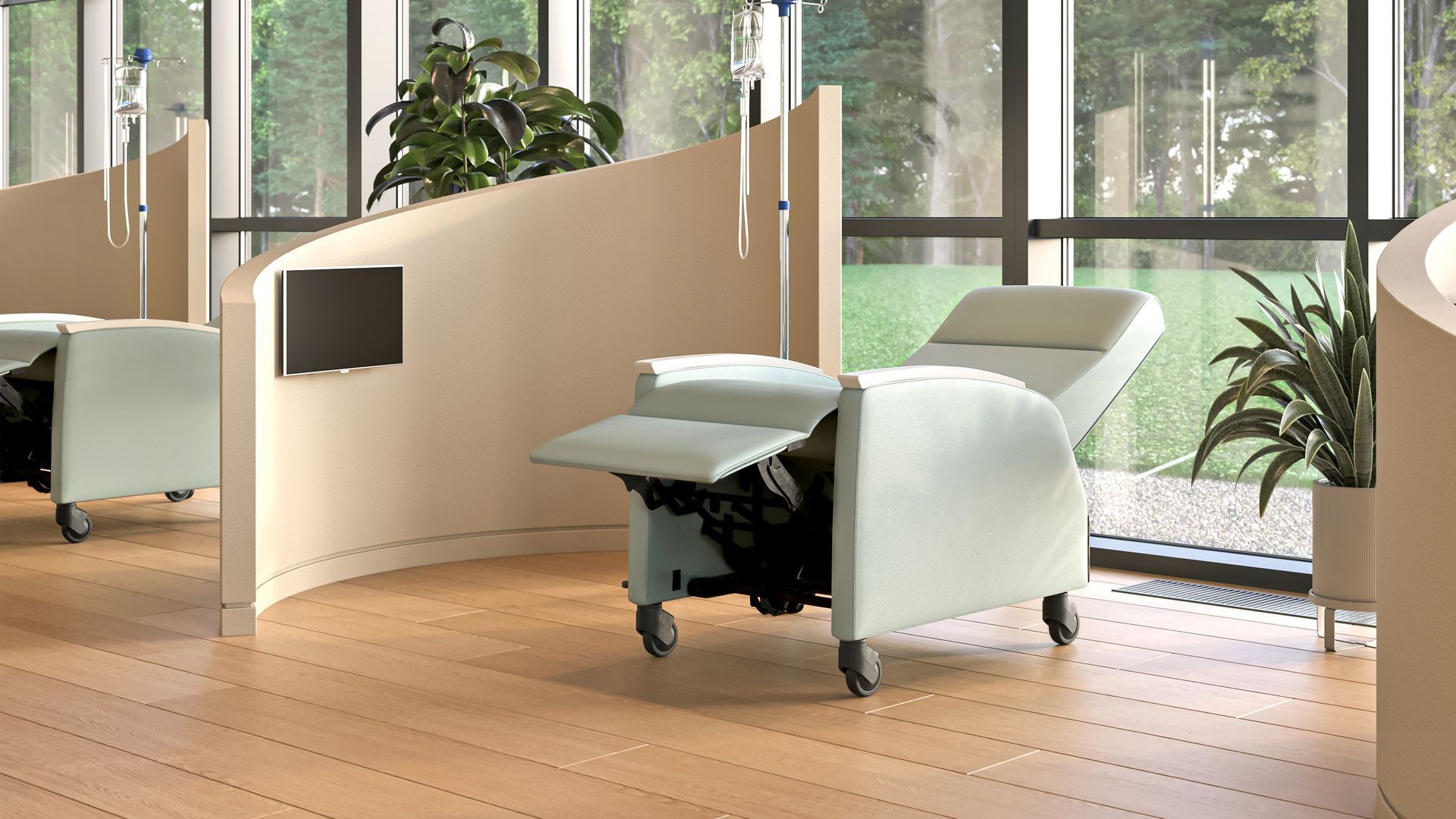 Modern medical treatment room with recliner, IV stand, and curved beige partition in front of window.