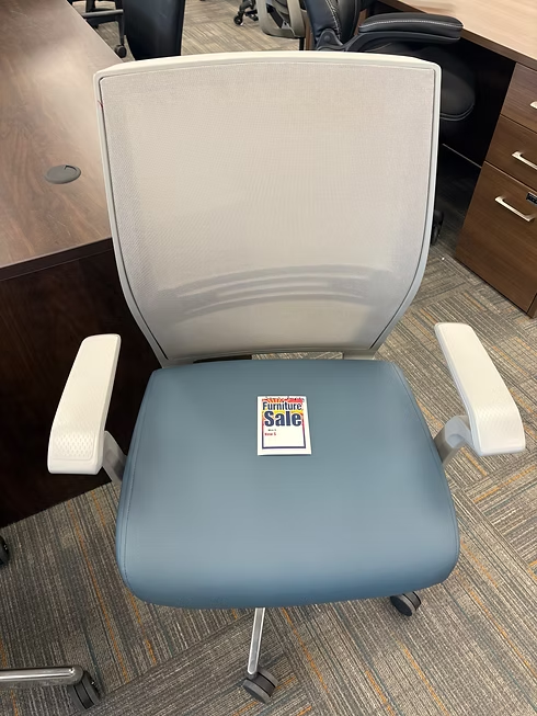 Blue and gray office chair with mesh back, white armrests, and a label on the seat.
