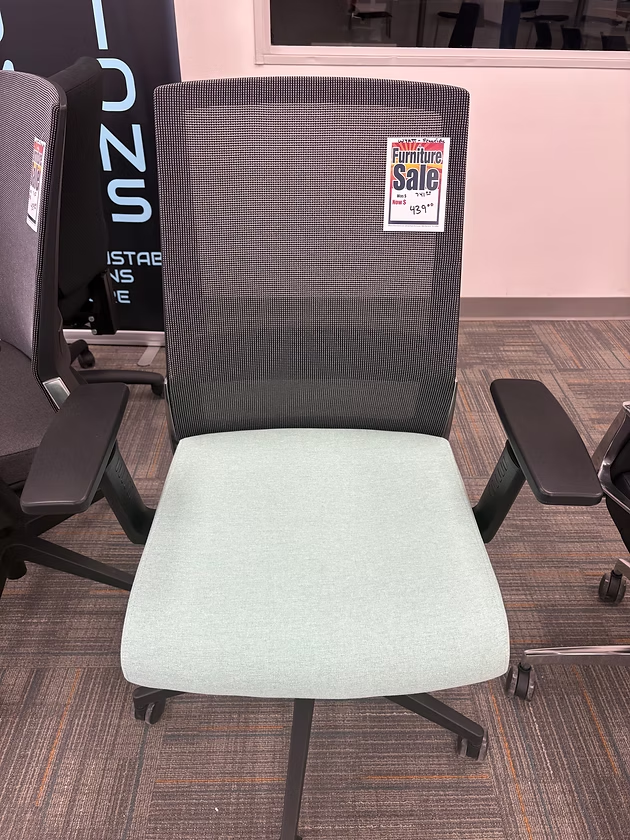 Mesh-back office chair with light green seat and attached black armrests; 