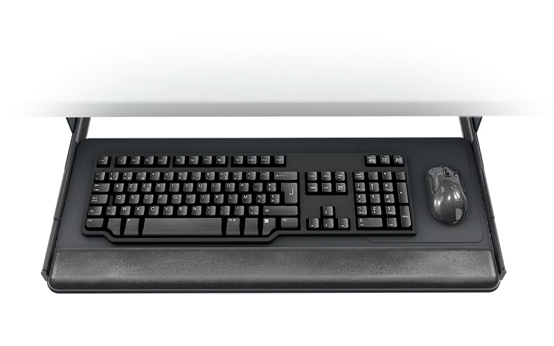 Black keyboard and mouse on an under-desk keyboard tray, with a wrist rest, against a white background.
