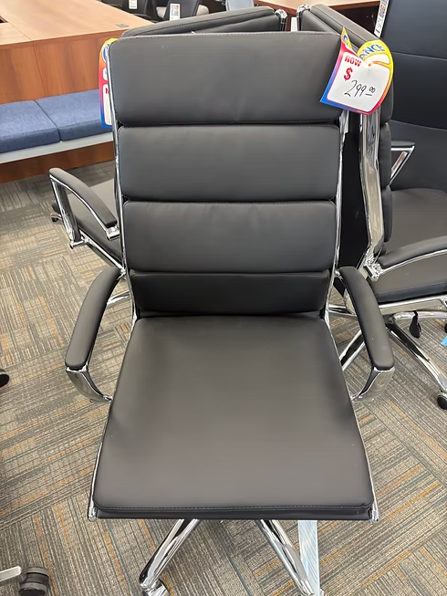 Black office chair with chrome accents; price tag visible.