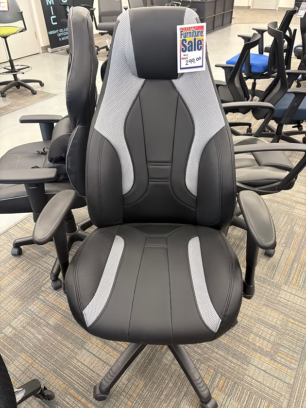 Black and gray office chair on sale in a store.