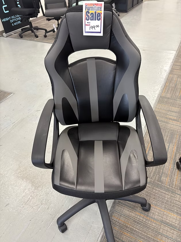 Black and gray gaming chair on sale, with a price tag.