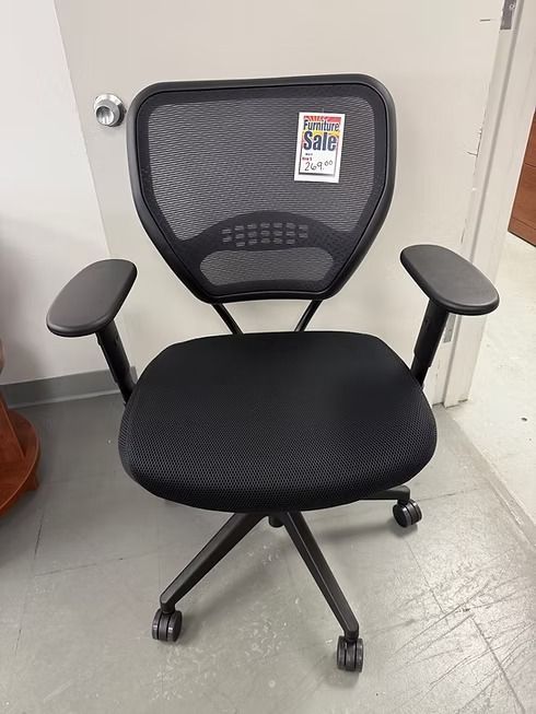 Black office chair with mesh back and padded seat; on sale.