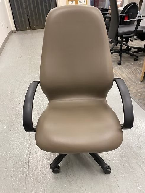 Brown office chair with black arms and base on a gray floor.