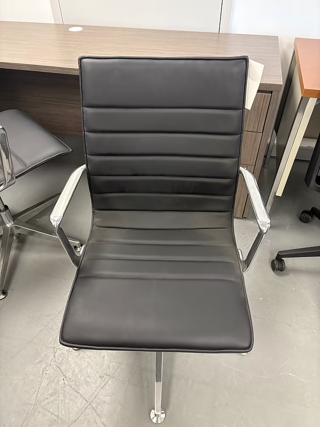 Black and silver office chair with horizontal stitched back and seat.