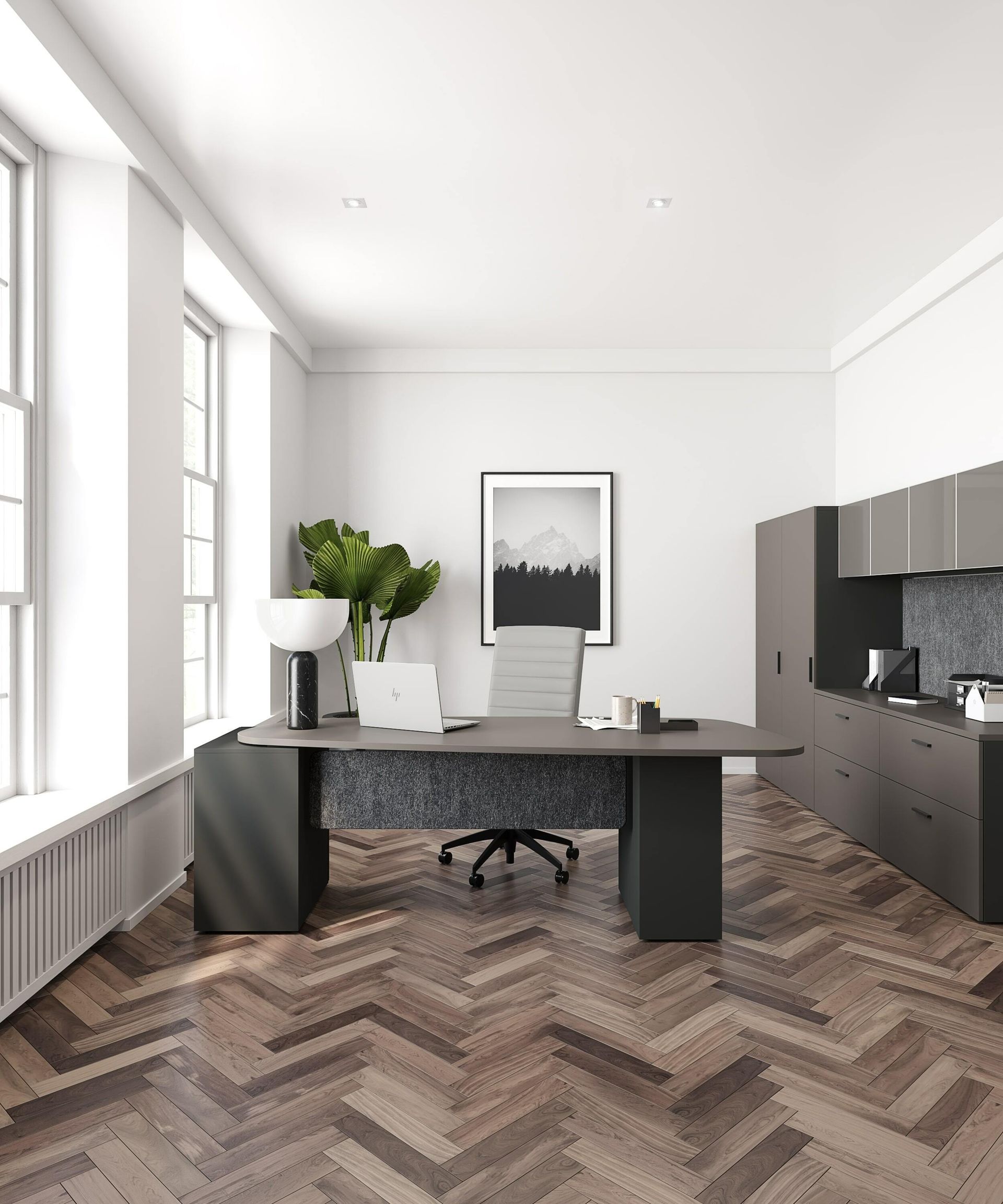 Office interior with desk, cabinets, large windows, and herringbone wood floor.