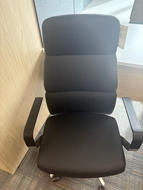 Black office chair with armrests, a cushioned back and seat.