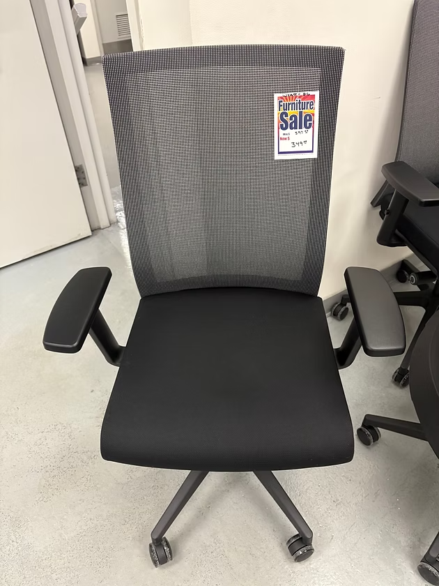 Black office chair with a mesh back and black seat, with 