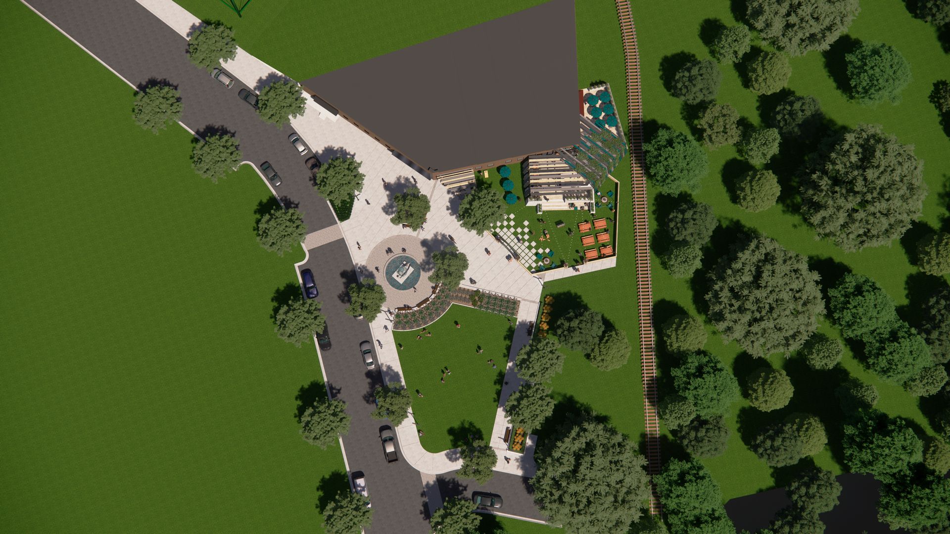 An aerial view of a park with trees and a road.