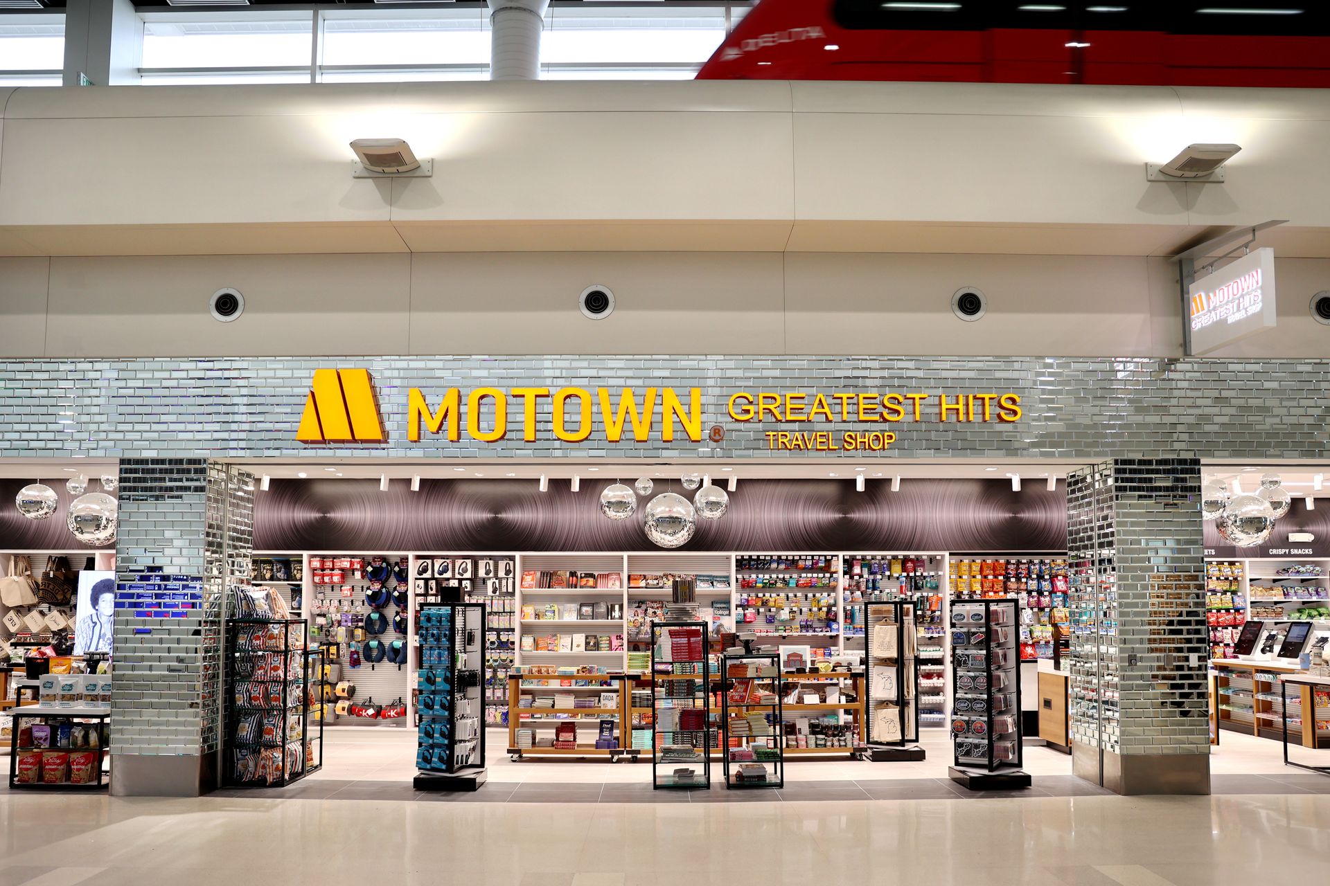 Motown Greatest Hits store entrance at a venue, featuring merchandise and signage.