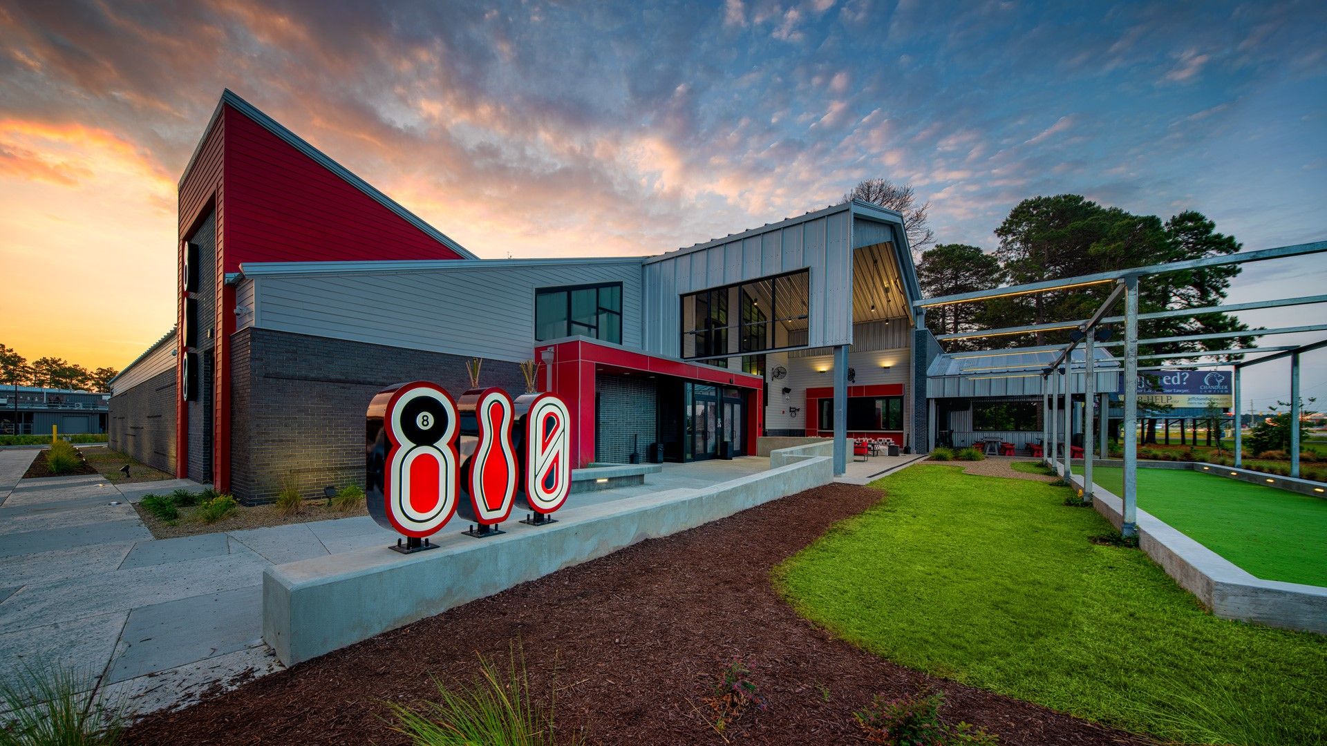 A large building with a sign in front of it that says 8:08.