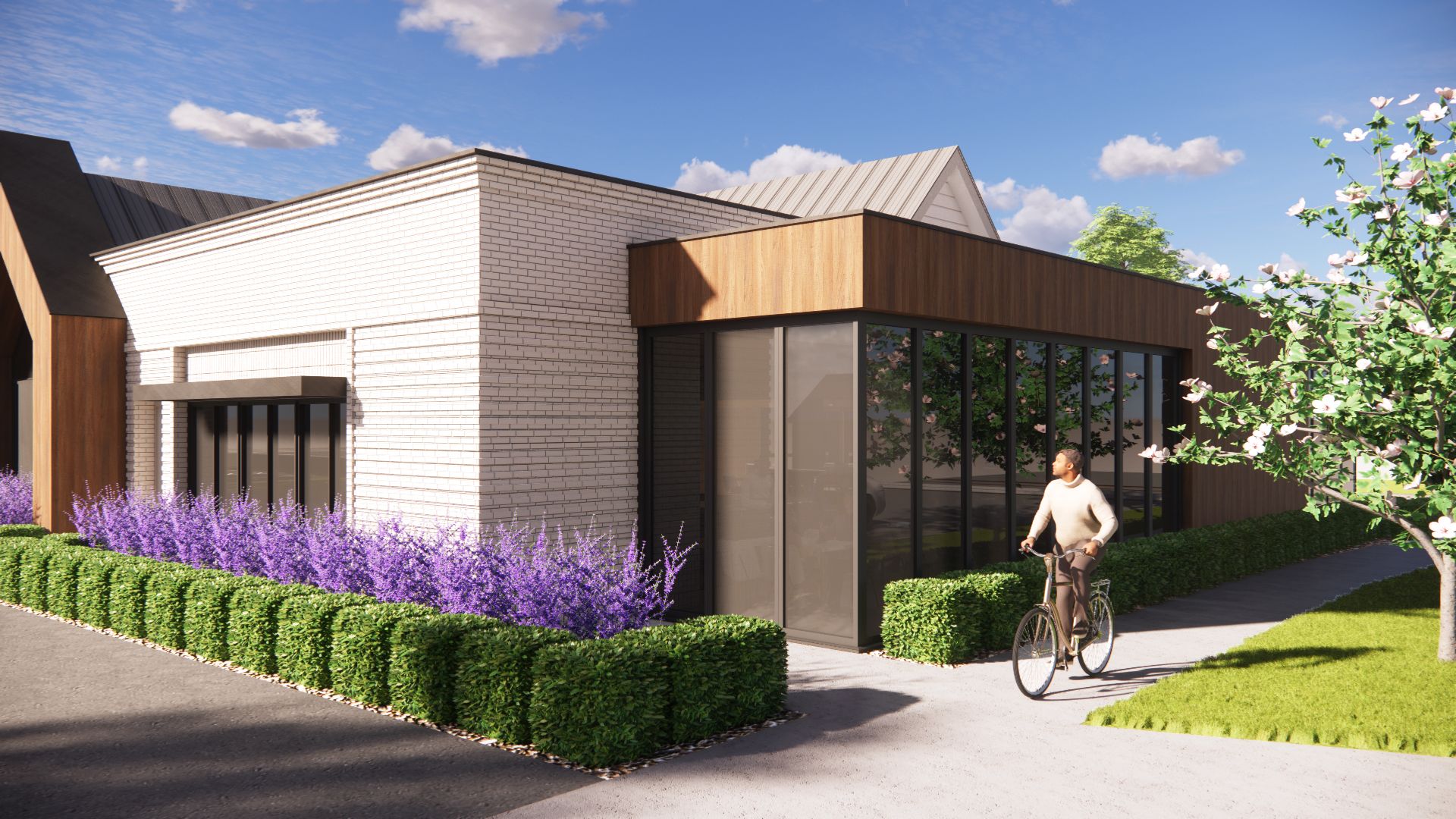 A modern building with glass windows, a cyclist, and purple flowers in a sunny outdoor setting.