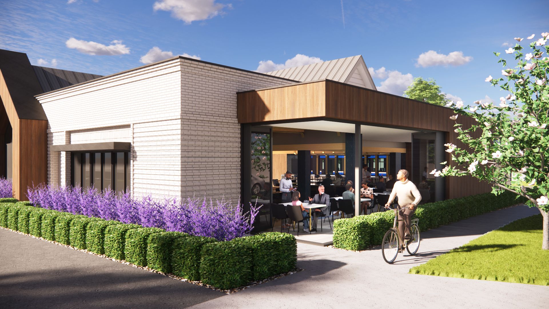 Cafe exterior with glass walls, a cyclist, and diners seated inside. Box hedge and lavender border the patio.