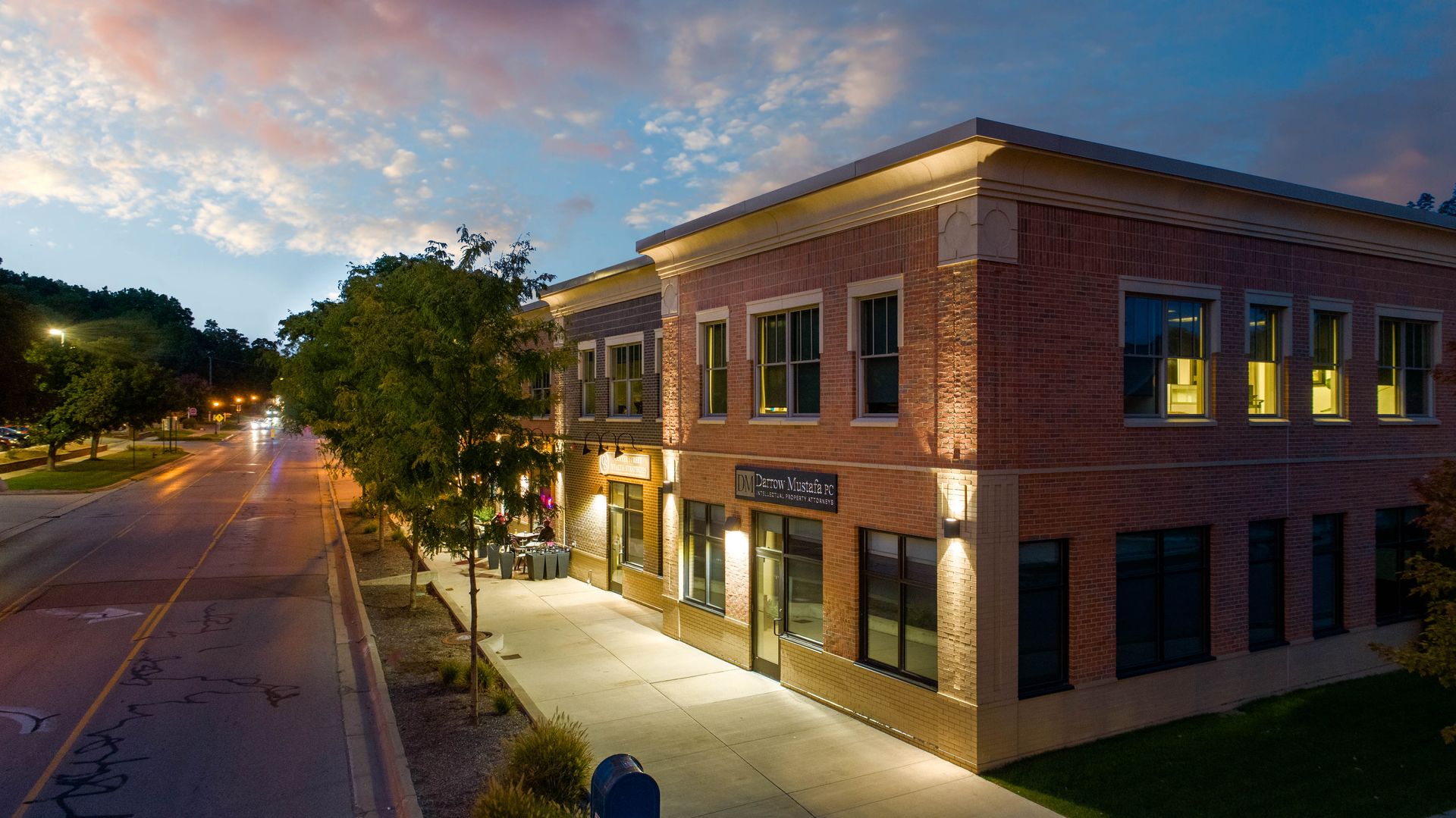 an aerial view of a large brick building with cars parked in front of it .