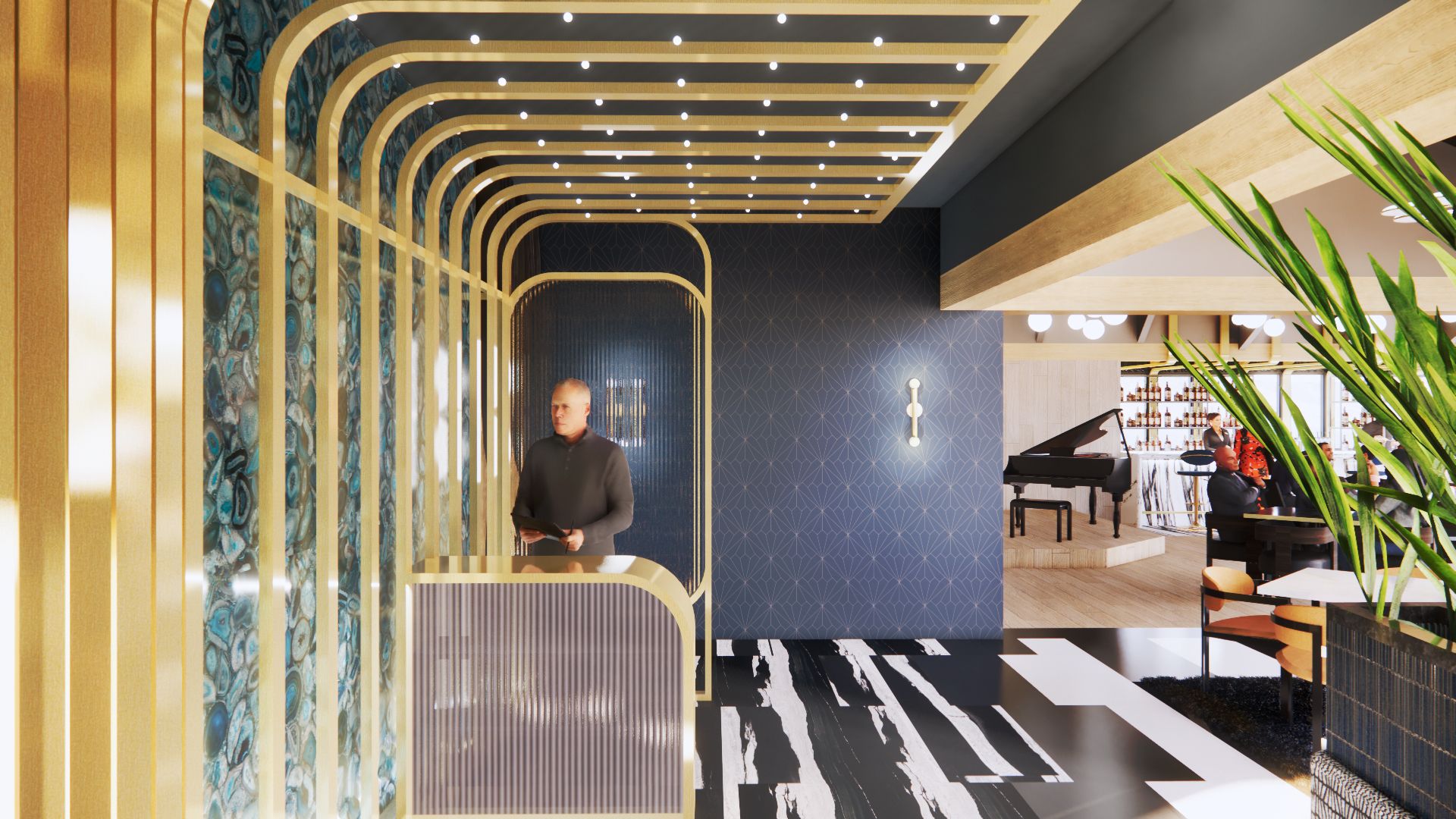 Man at reception desk inside a stylish building with a piano in the background.