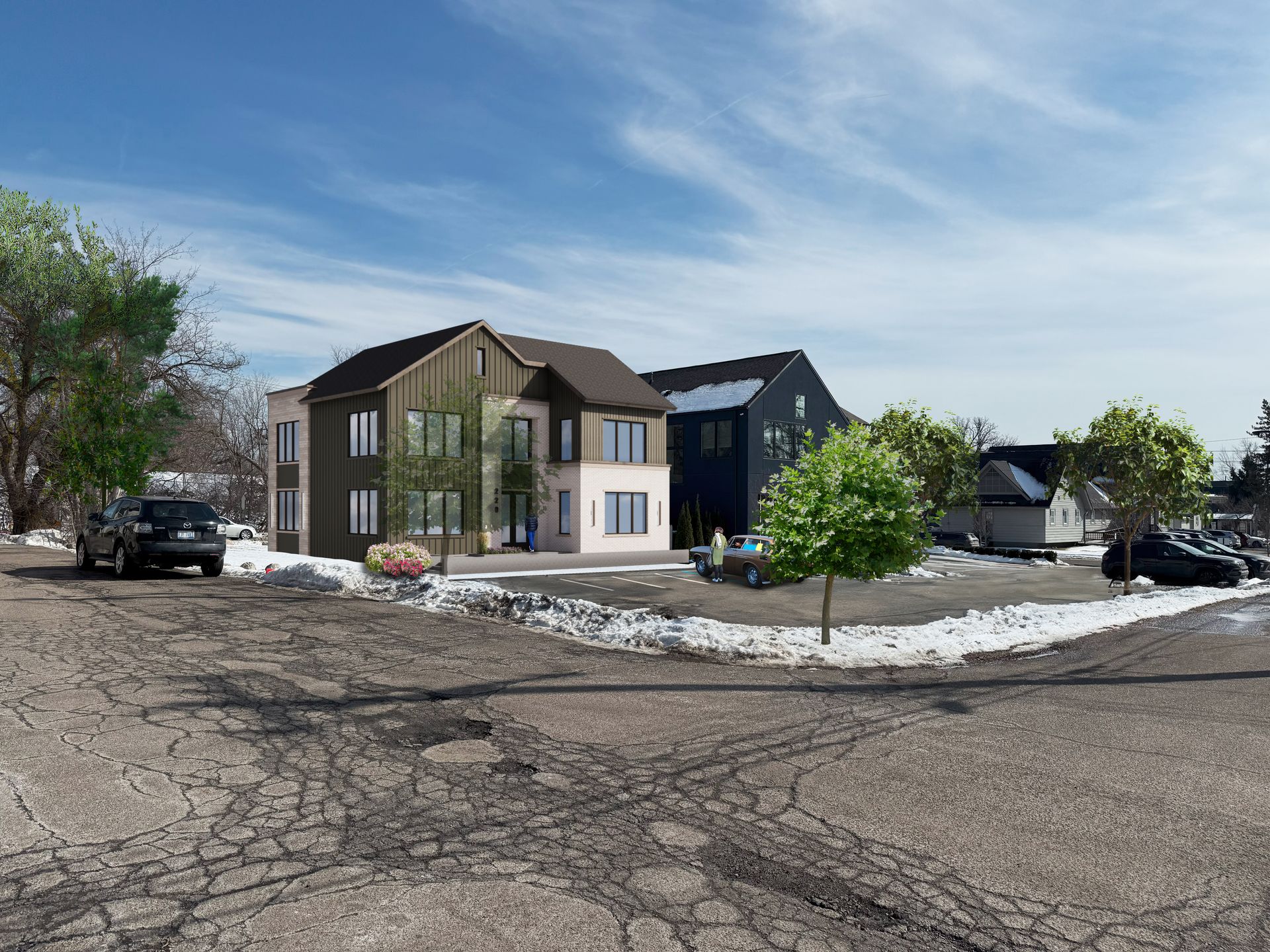 Two-story houses on a cracked road with patchy snow, car parked on the left, trees, and blue sky.