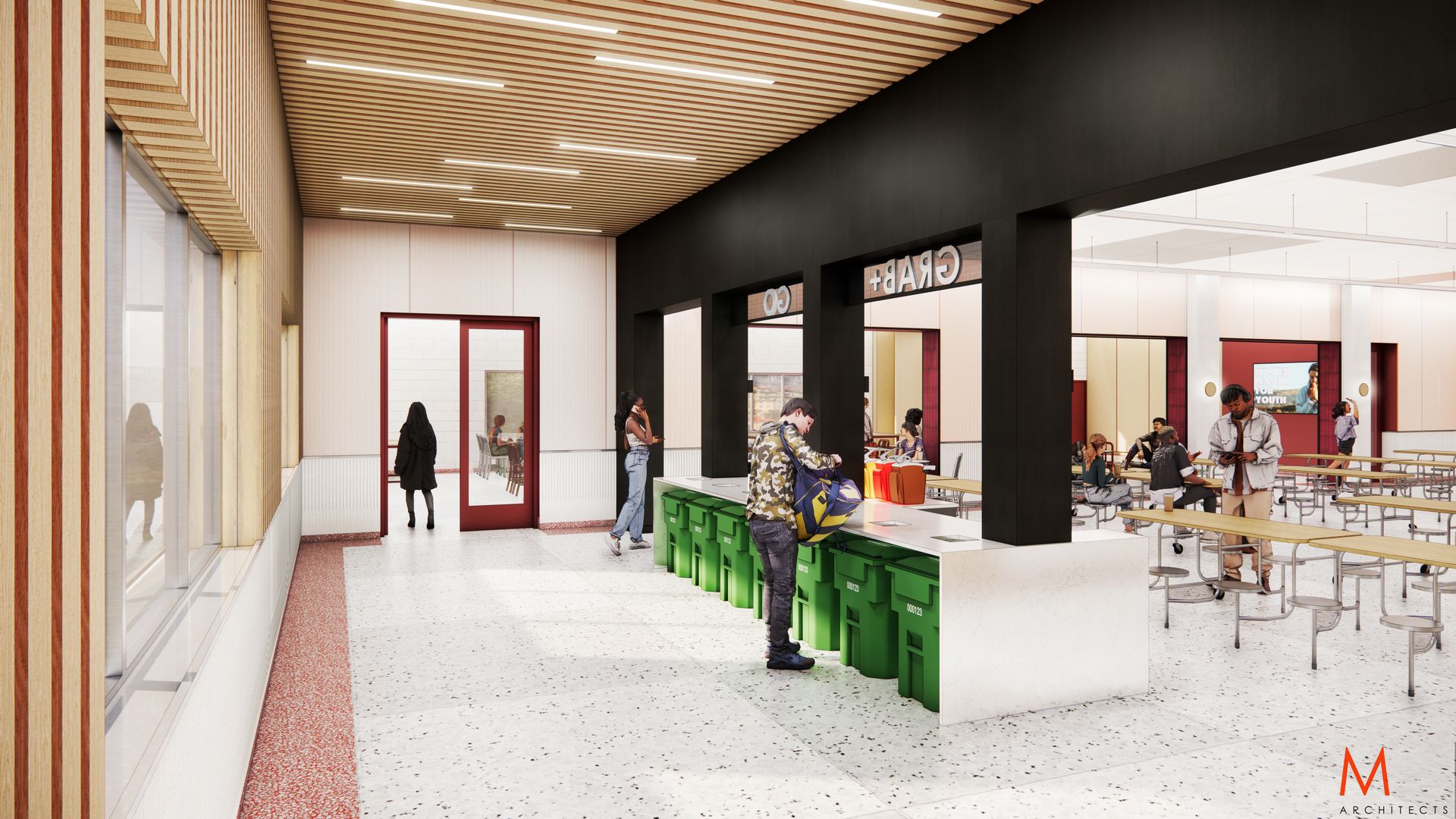 Interior school hallway with students, tables, and a red-trimmed door. Green trash bins and a wood-paneled ceiling are visible.