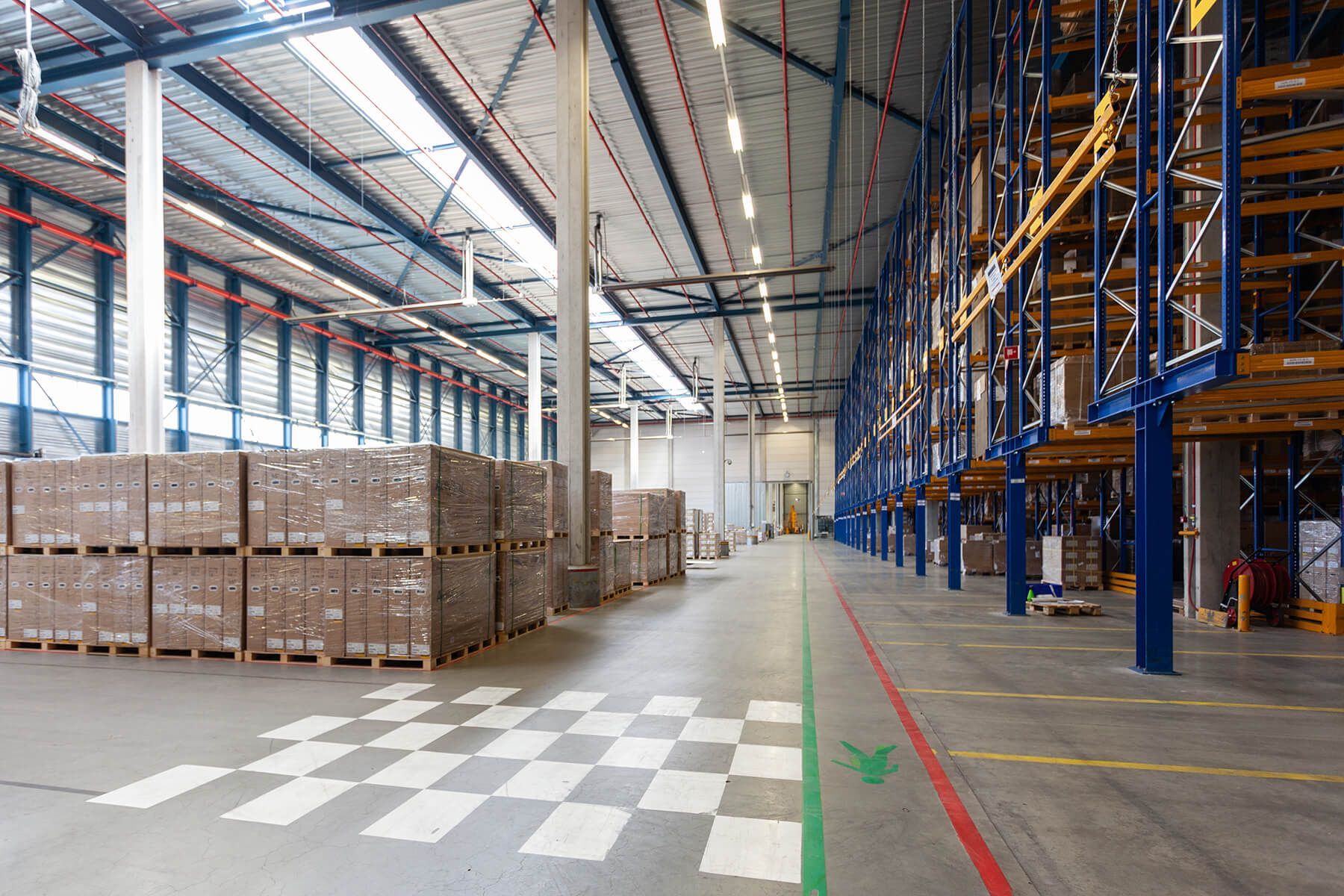 a large warehouse filled with lots of boxes and shelves .