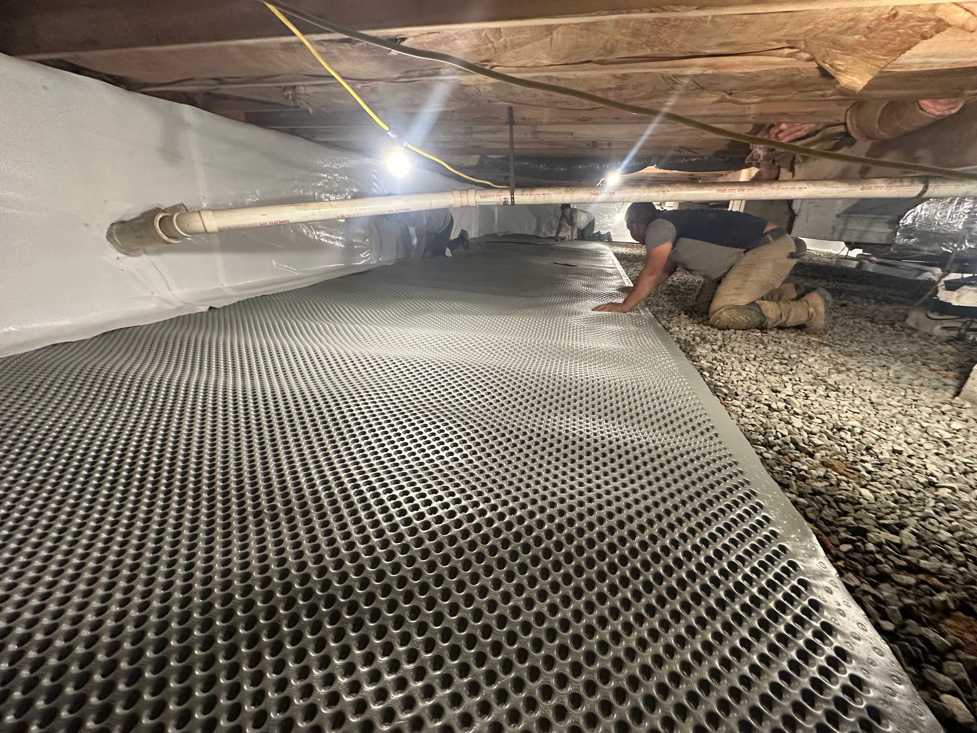 Crawl space encapsulation installation with vapor barrier flooring by Elite Basement Solutions