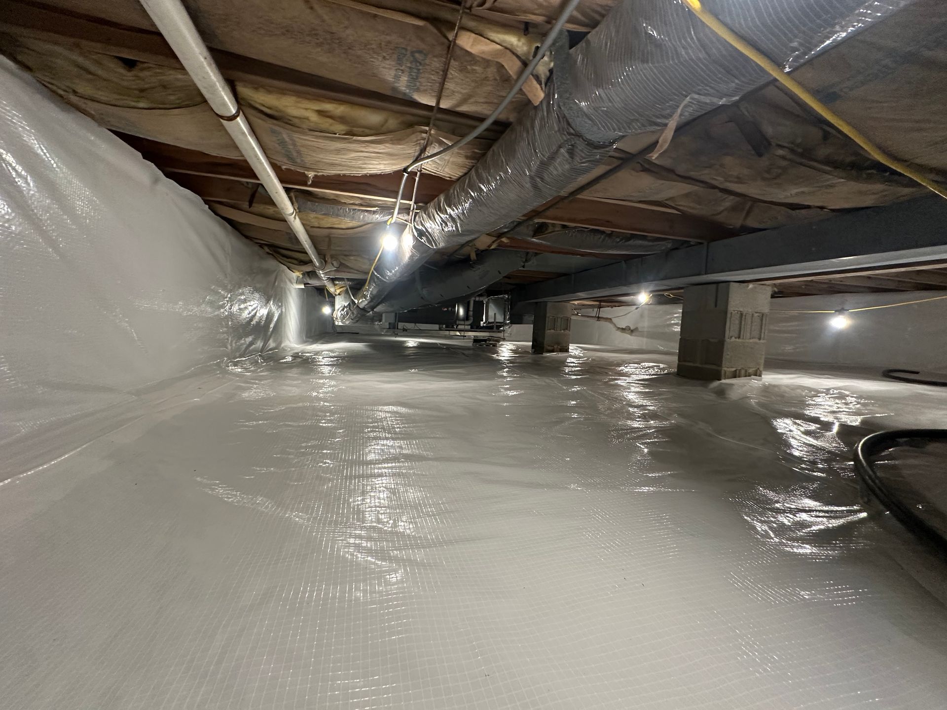 Completed crawl space encapsulation with sealed floor and walls by Elite Basement Solutions