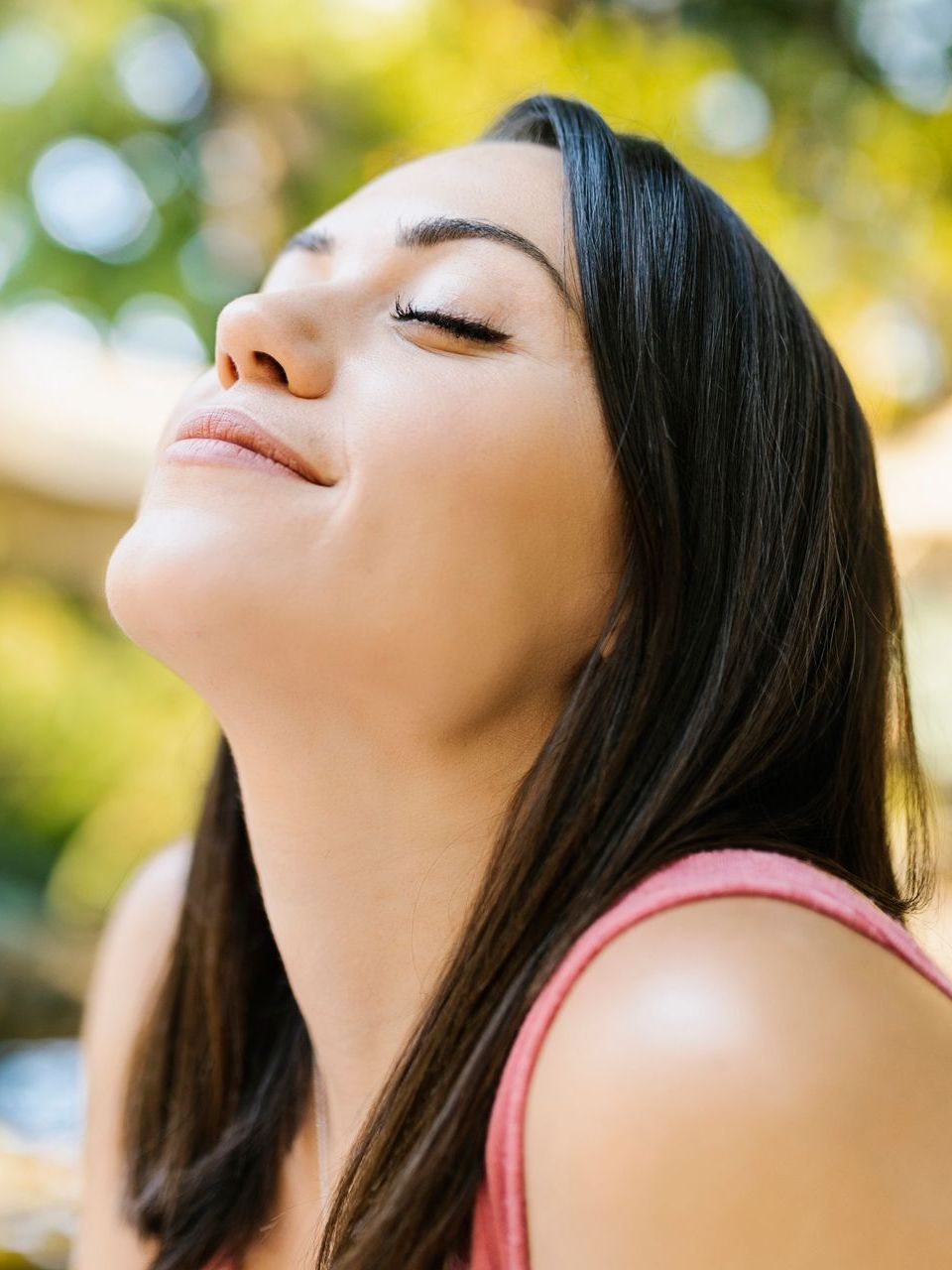 Woman breathing deeply outdoors with eyes closed, representing improved airflow after LATERA nasal valve implant supporting nasal sidewall