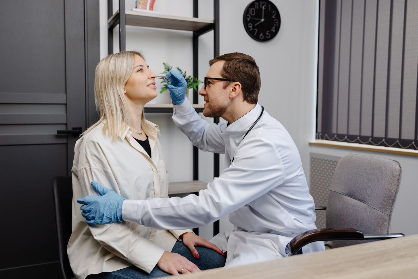 A sinus specialist checking the nose of his patient