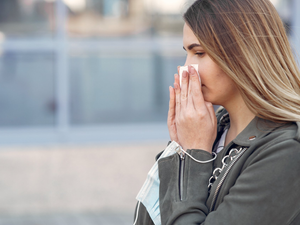 Woman experiencing nasal congestion and stuffy nose
