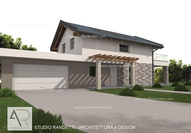 Esterno di una moderna casa a due piani con garage, dettagli in pietra e ingresso coperto.