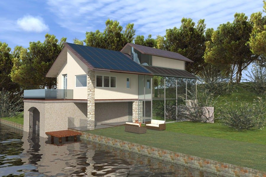 Casa a due piani in riva al mare con molo, muro di contenimento in pietra e giardino erboso.