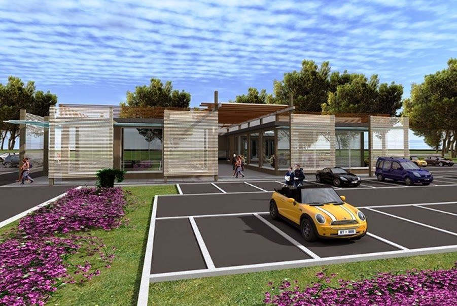 Parcheggio moderno con una decappottabile gialla davanti a un edificio basso con pareti in vetro e aiuole di fiori rosa.