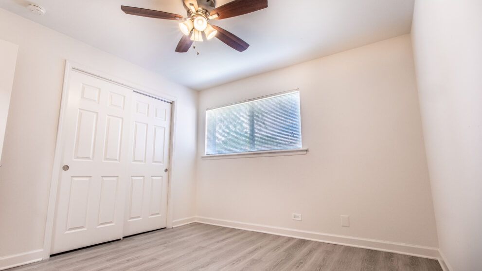 photo showing small with with large closet and ceiling fan