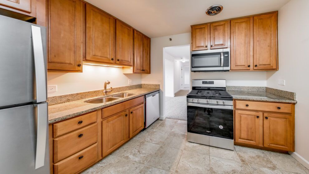 photo showing kitchen with hallway in background