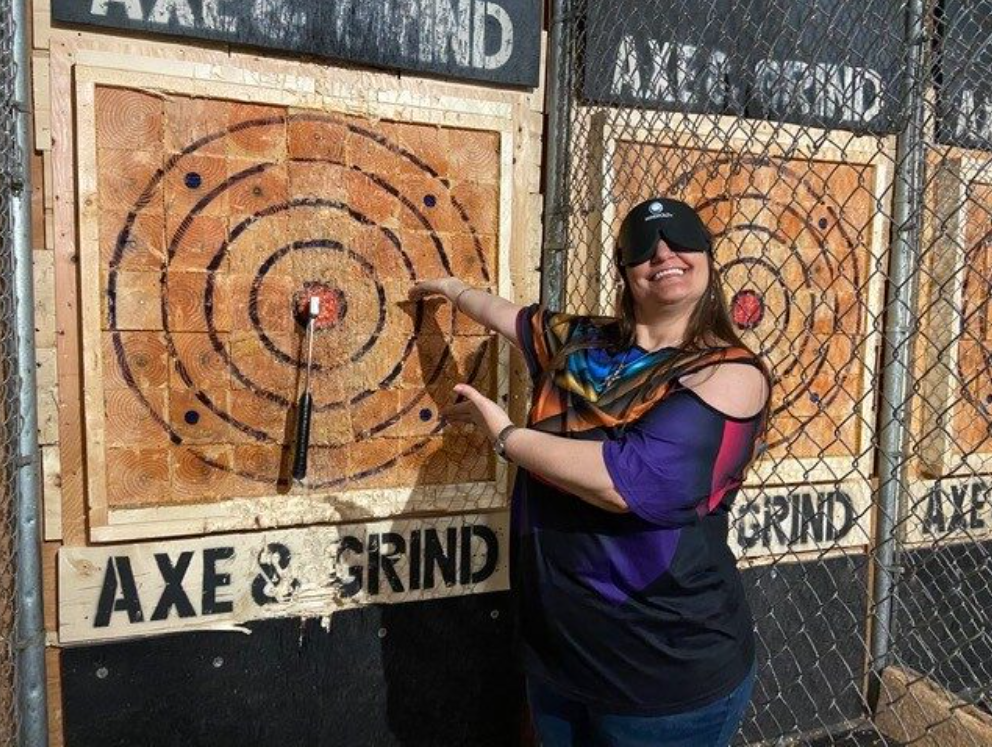 Gina showing her axe-throwing bullseye she got while blindfolded