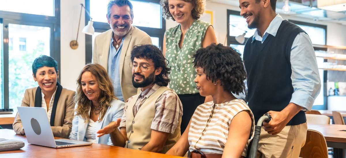 Group of team members in front laptop on a video call.