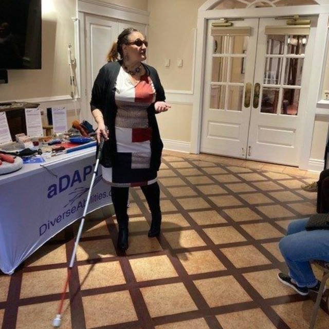 Gina presenting in front a table with educational tools on it