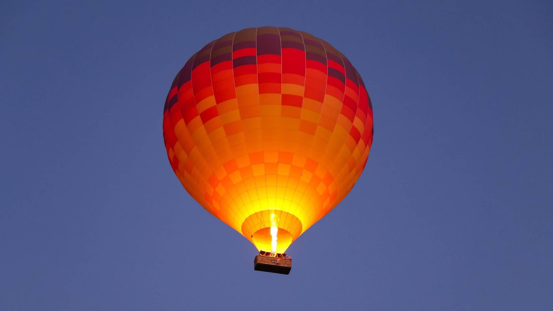 Orange and red hot air balloon flying