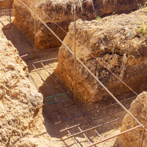 A construction site with a lot of dirt and concrete.